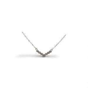 Elegant V-shaped necklace with white stones and a button setting